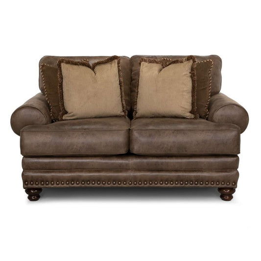 Brown leather loveseat with tan pillows and studded trim.