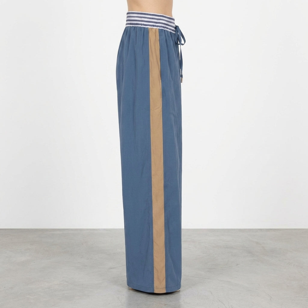 Wide-leg pants with a beige stripe and blue drawstring waistband.