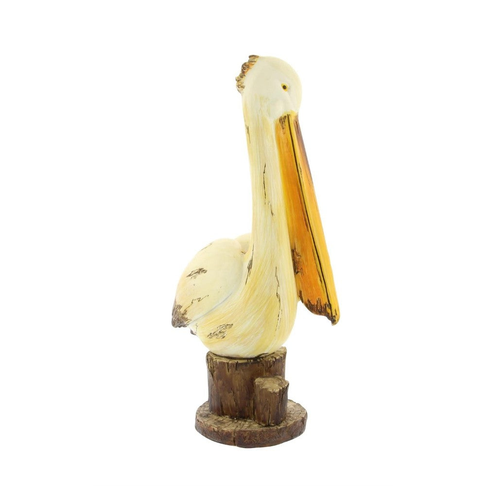 Wooden pelican sculpture on a small stand.