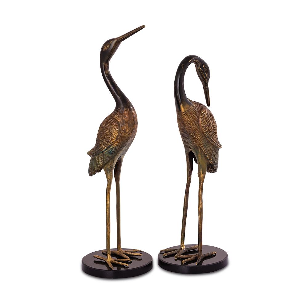 Two bronze crane sculptures on black bases.