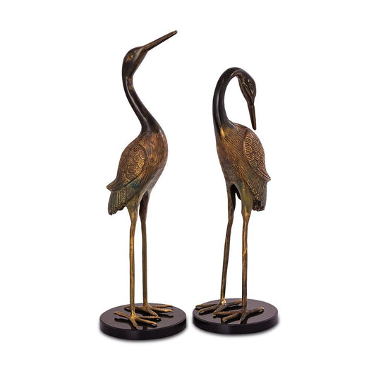 Two bronze crane sculptures on black bases.