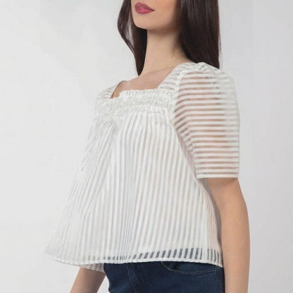 Woman in striped sheer white blouse, side view.