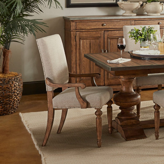 Elegant dining setup with wooden furniture and a potted plant.