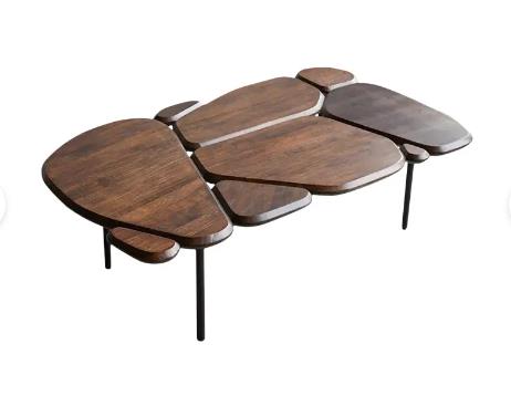 Modern coffee table with irregular wooden shapes and black metal legs.