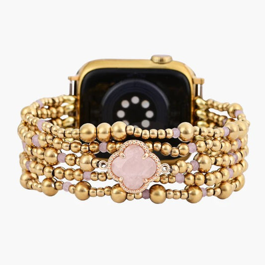 Gold watch with a beaded bracelet and floral centerpiece.