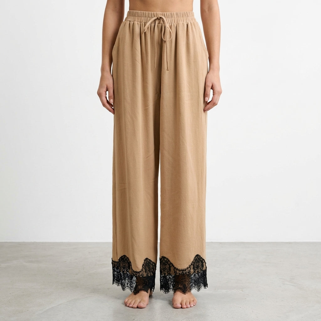 Beige wide-leg pants with black lace trim at the hem.