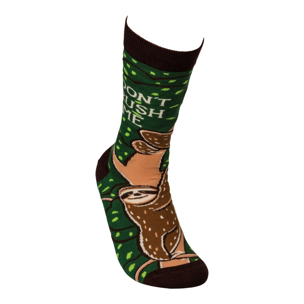 Green sock with sloth pattern, text reads "DON'T RUSH ME."
