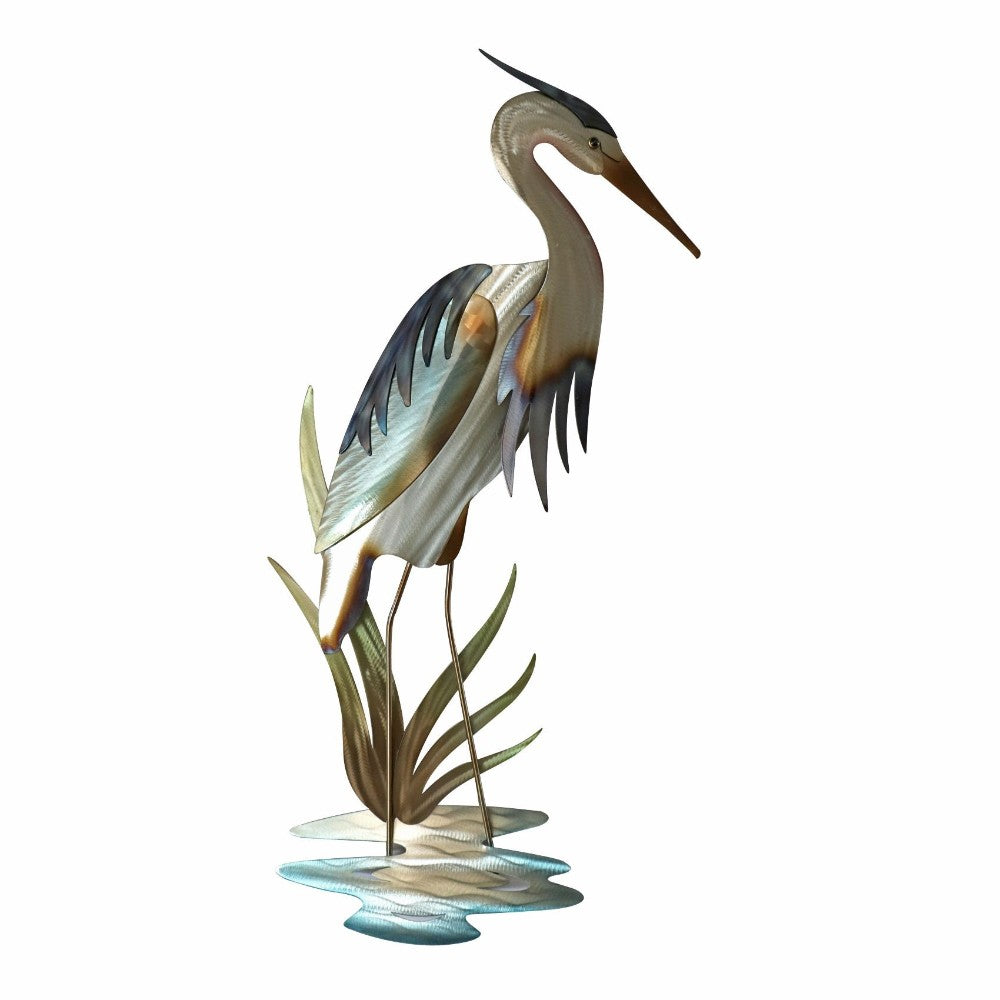 Colorful metal heron sculpture wading in water.