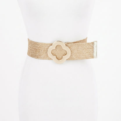Beige belt with a floral buckle on a mannequin.