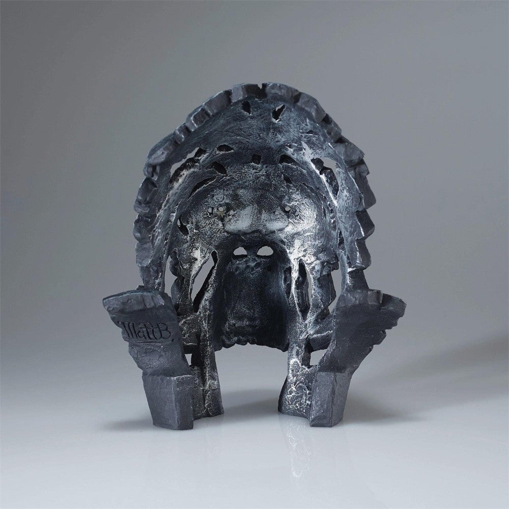 Futuristic, abstract dark sculpture with intricate textures resembling a mask.