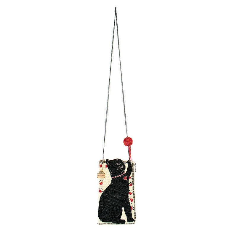 Cat-themed crossbody bag with a chain strap and red pom-pom accessory.