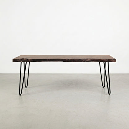 Wooden table with metal hairpin legs on white background.