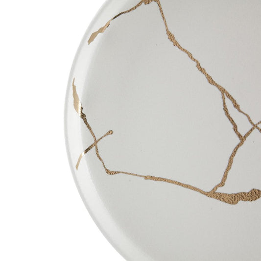 White plate with gold kintsugi lines.