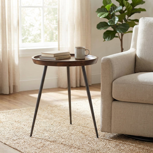 Round wooden table with three slender metal legs.