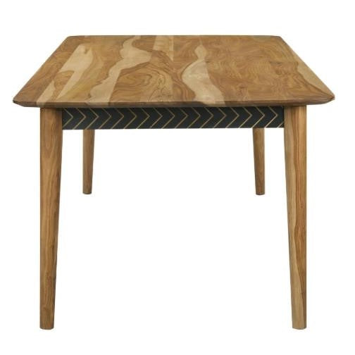 A wooden table with a patterned black apron and a natural-grain top.