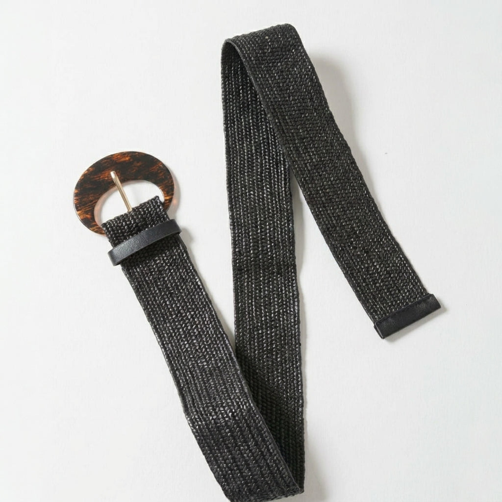 Black woven belt with a round, tortoiseshell-style buckle.