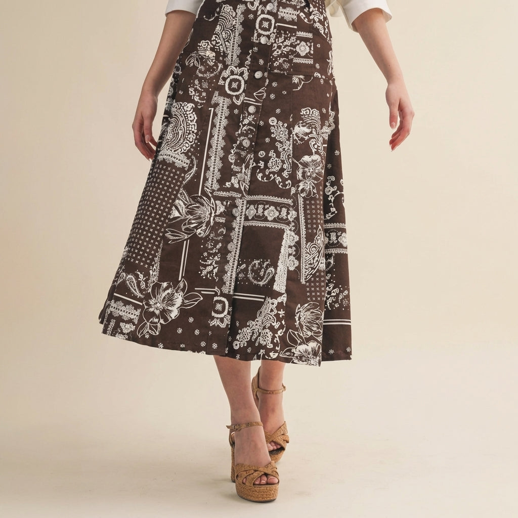 Woman wearing a patterned brown skirt and tan platform heels.