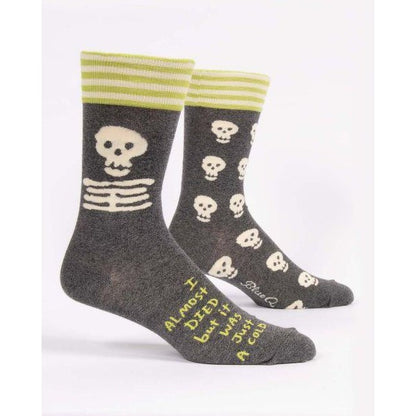 Gray socks with skulls, stripes, and humorous text.