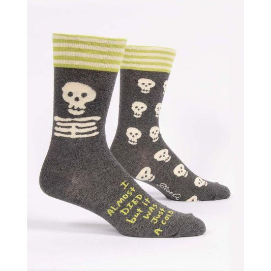 Gray socks with skulls, stripes, and humorous text.