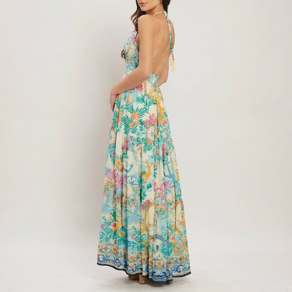 Woman in a vibrant, backless floral maxi dress, side view.
