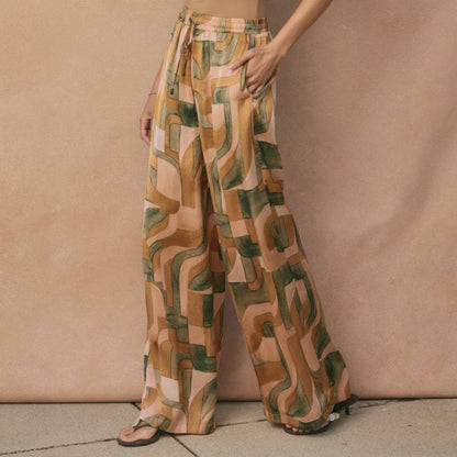 Wide-leg pants with a retro geometric pattern in earthy tones.