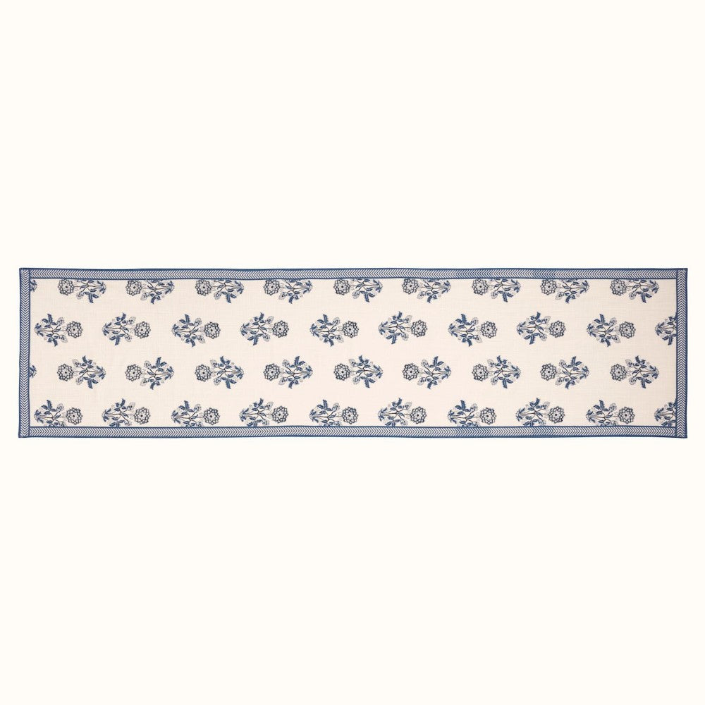 White table runner with blue floral patterns and borders.