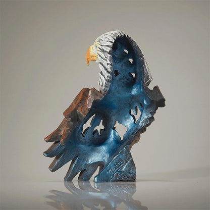 Abstract eagle sculpture with blue, brown, and silver tones.