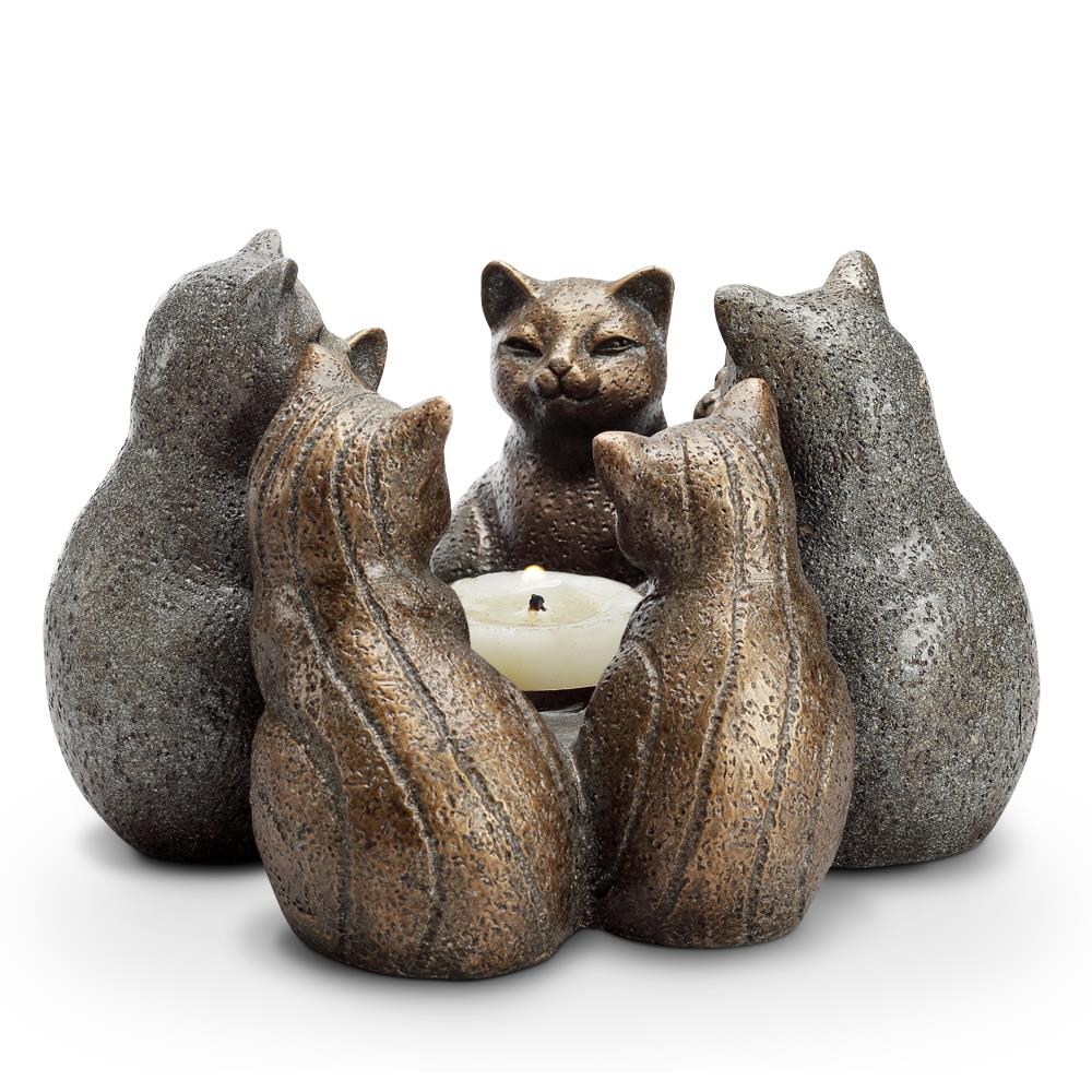 Cat statues encircle a candle in a circle.
