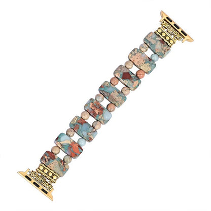 Colorful stone watch band with gold connectors.