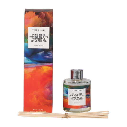 Colorful reed diffuser packaging with humorous text and included fragrance sticks.