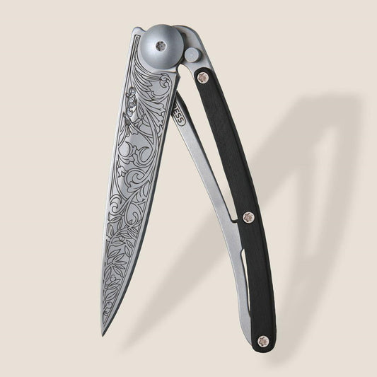 Elegant knife with intricate floral engravings on the blade.