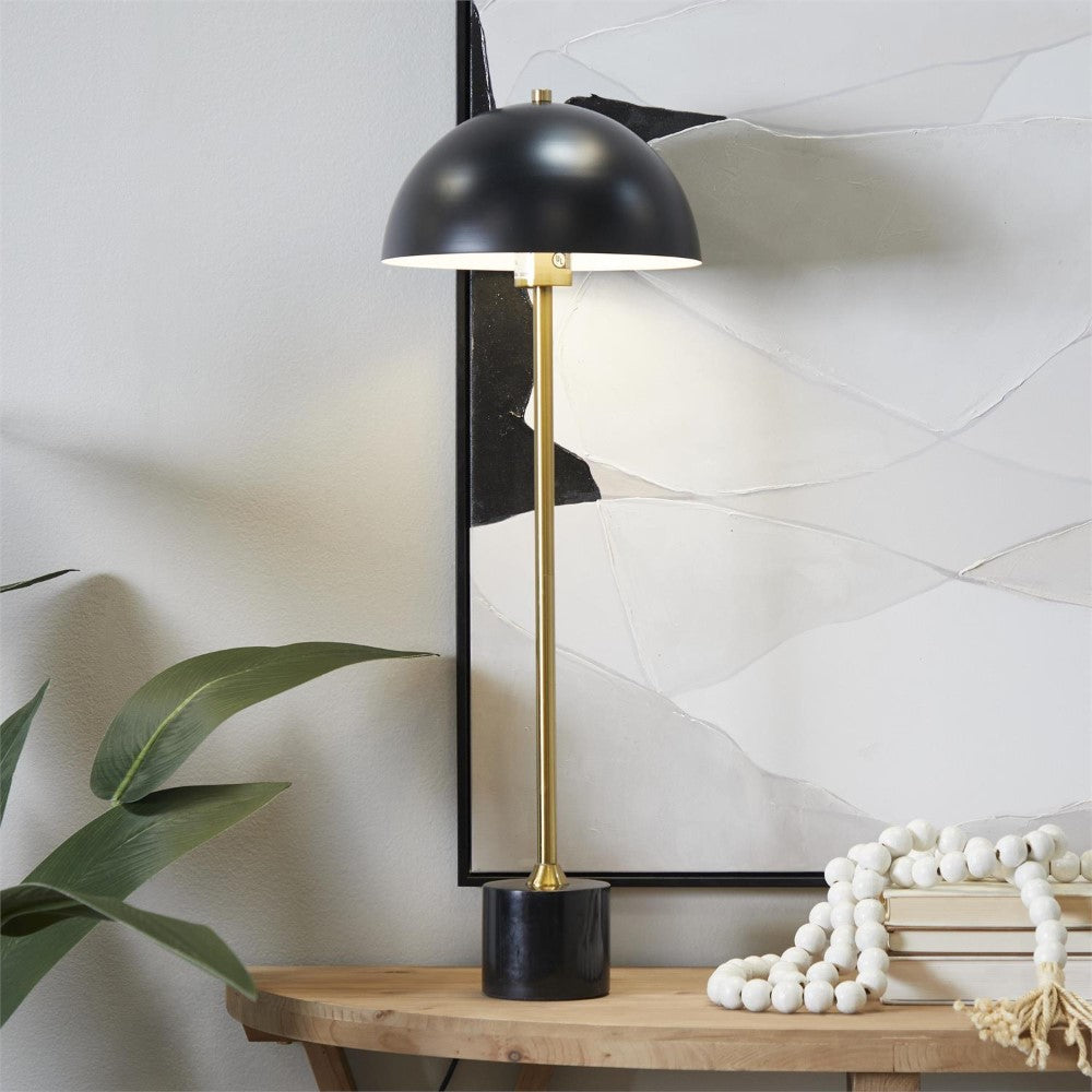 Modern lamp on wooden table, abstract art, plant decor.