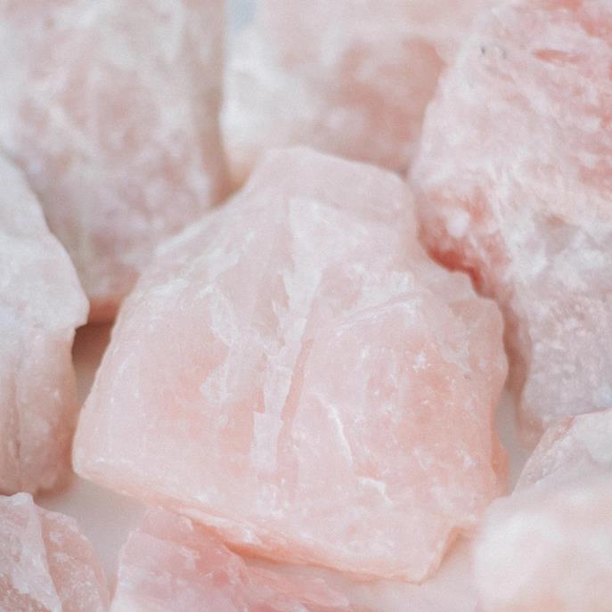 Close-up of pink rose quartz crystals with a soft, natural texture.