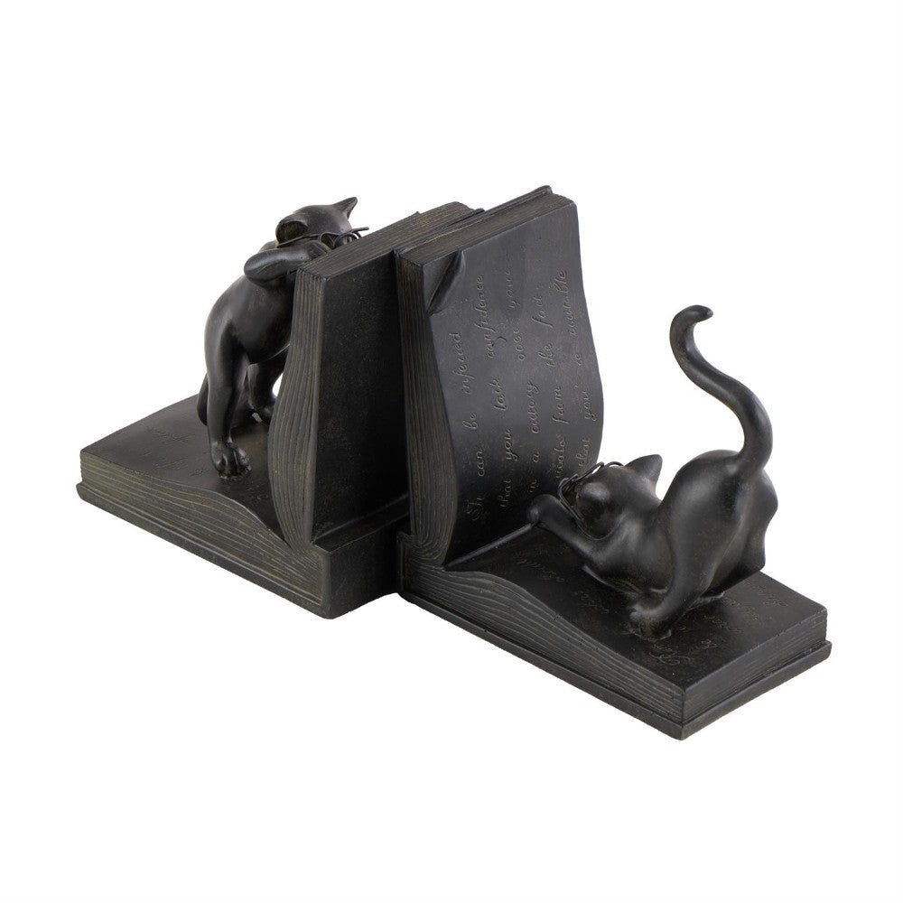 Cat bookends holding up an open book.