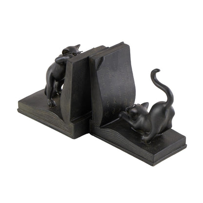 Cat bookends holding up an open book.