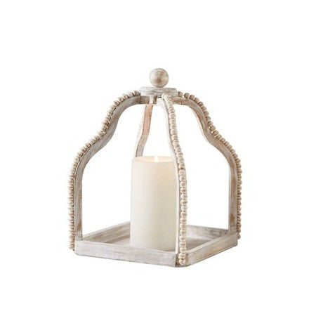 Wood-framed lantern with a candle inside.