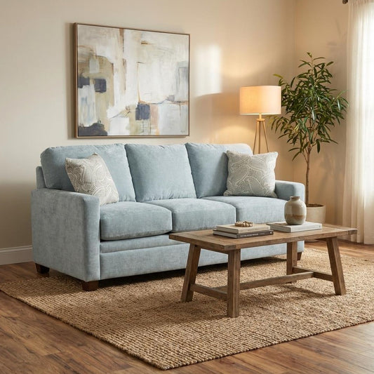 Cozy living room with blue sofa, wooden table, and abstract artwork.