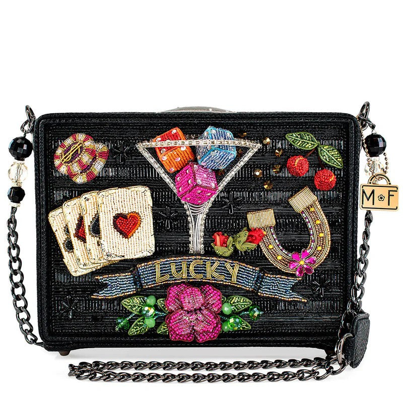 Beaded handbag with lucky symbols: cards, dice, horseshoe, cherries, and flowers.