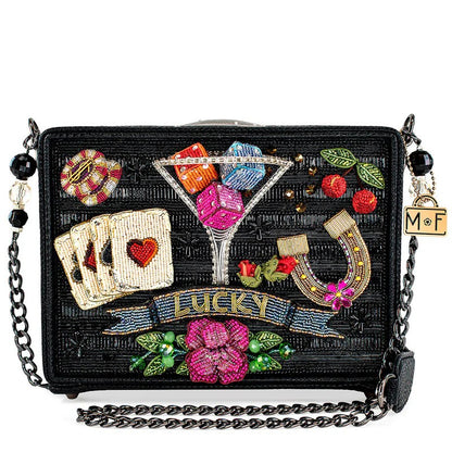 Beaded handbag with lucky symbols: cards, dice, horseshoe, cherries, and flowers.