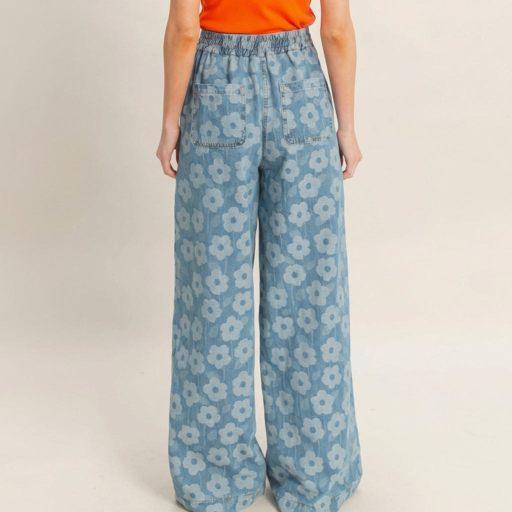 Blue floral wide-leg pants with an orange top, viewed from the back.