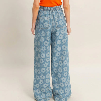 Blue floral wide-leg pants with an orange top, viewed from the back.