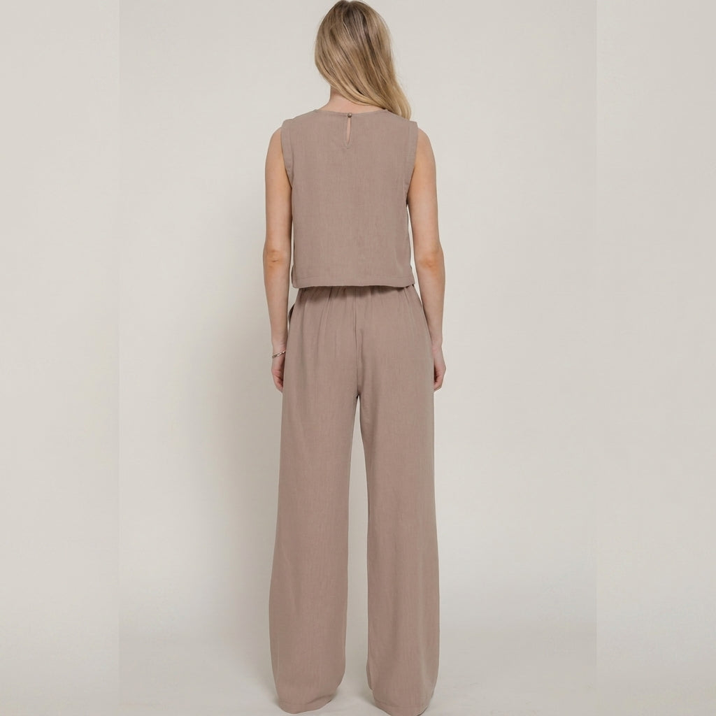 Woman in beige outfit facing away.
