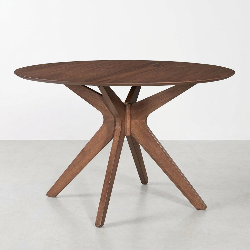 Round wooden table with modern geometric legs.