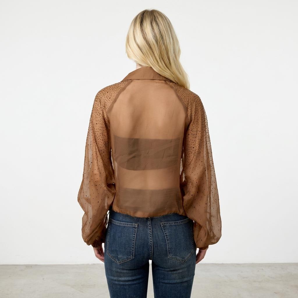 Person in sheer brown blouse and jeans, seen from the back.