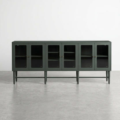 Green cabinet with glass doors and interior shelves.