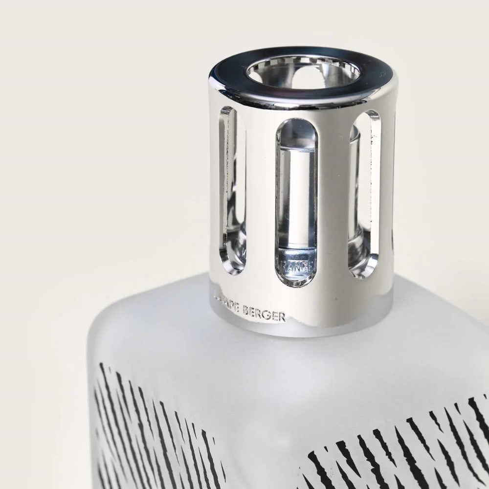 Silver-capped frosted glass bottle with vertical black stripes.