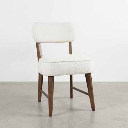 Modern chair with wooden legs and white upholstered seat and backrest.
