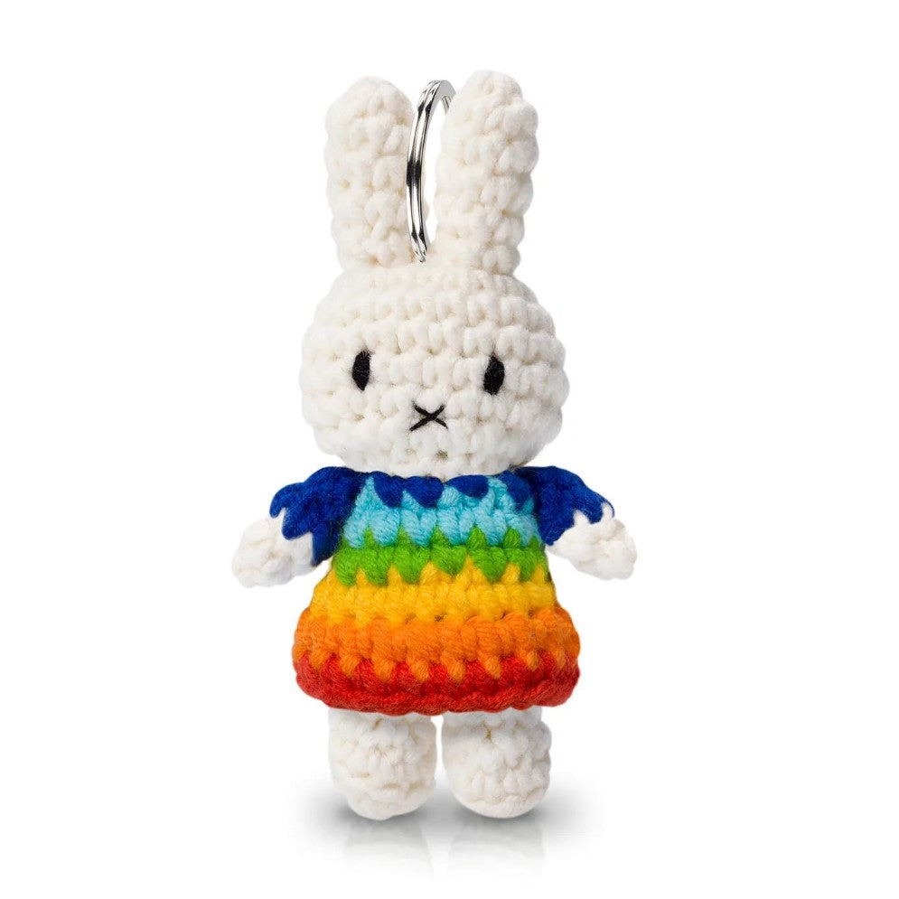 Crocheted rabbit keychain in a colorful rainbow dress.