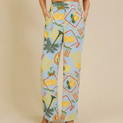 Colorful, lemon-patterned wide-leg pants with pockets and a relaxed fit.