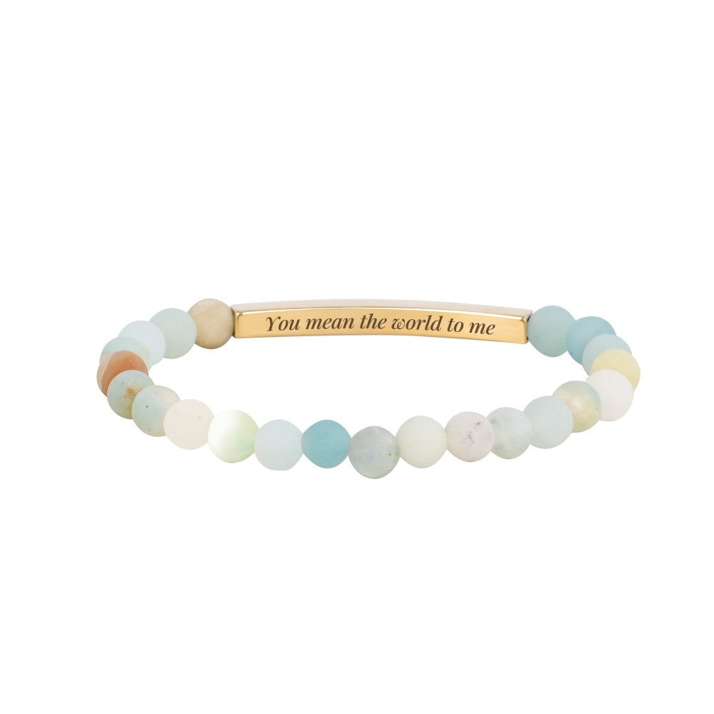 A beaded bracelet with "You mean the world to me" on a gold plate.